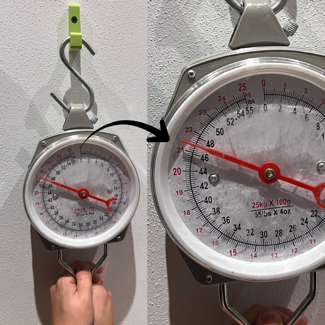 Belastungstest für einen 3d-gedruckten Wandhaken in der Farbe Apfelgrün. Die Waage zeugt über 21kg an. Die angegebene Belastung liegt bei 20kg
