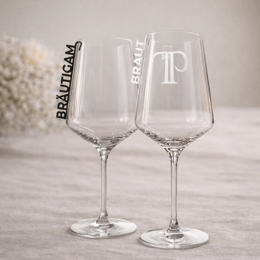 2 Gläser stehen auf einem festlichen Tisch und haben Glasmarkierer an der Seite hängen