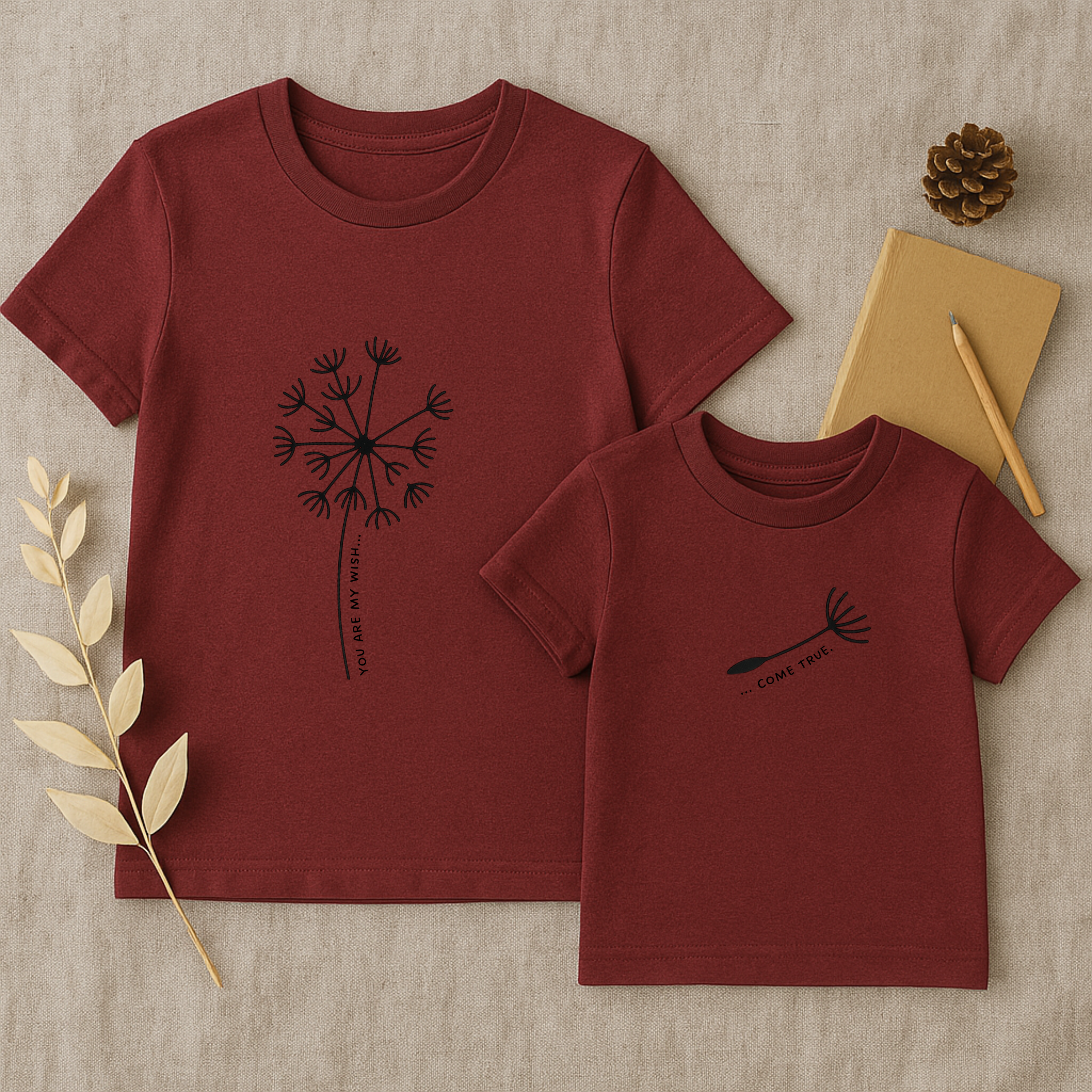 Mama-Kind-Shirt-Set aus Bio-Baumwolle mit geteiltem Spruch: „You are my wish … come true“. BUrgundrotes T-Shirt für Mama mit Pusteblume und fehlendem Schirmchen, passendes Kind-Shirt mit einzelner Pusteblumenschirmchen-Grafik. Hochwertig, nachhaltig, ideal als Muttertagsgeschenk, zur Geburt oder für Familienfotos. Perfektes Geschenk für Mamas und Kinder – liebevoll, modern und emotional gestaltet.